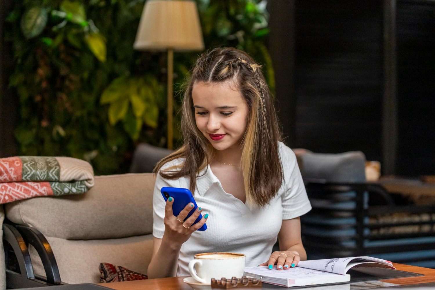 A girl uses a phone in a blue case
